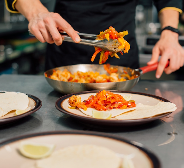 cookingclass Close-up of chef serving burritos